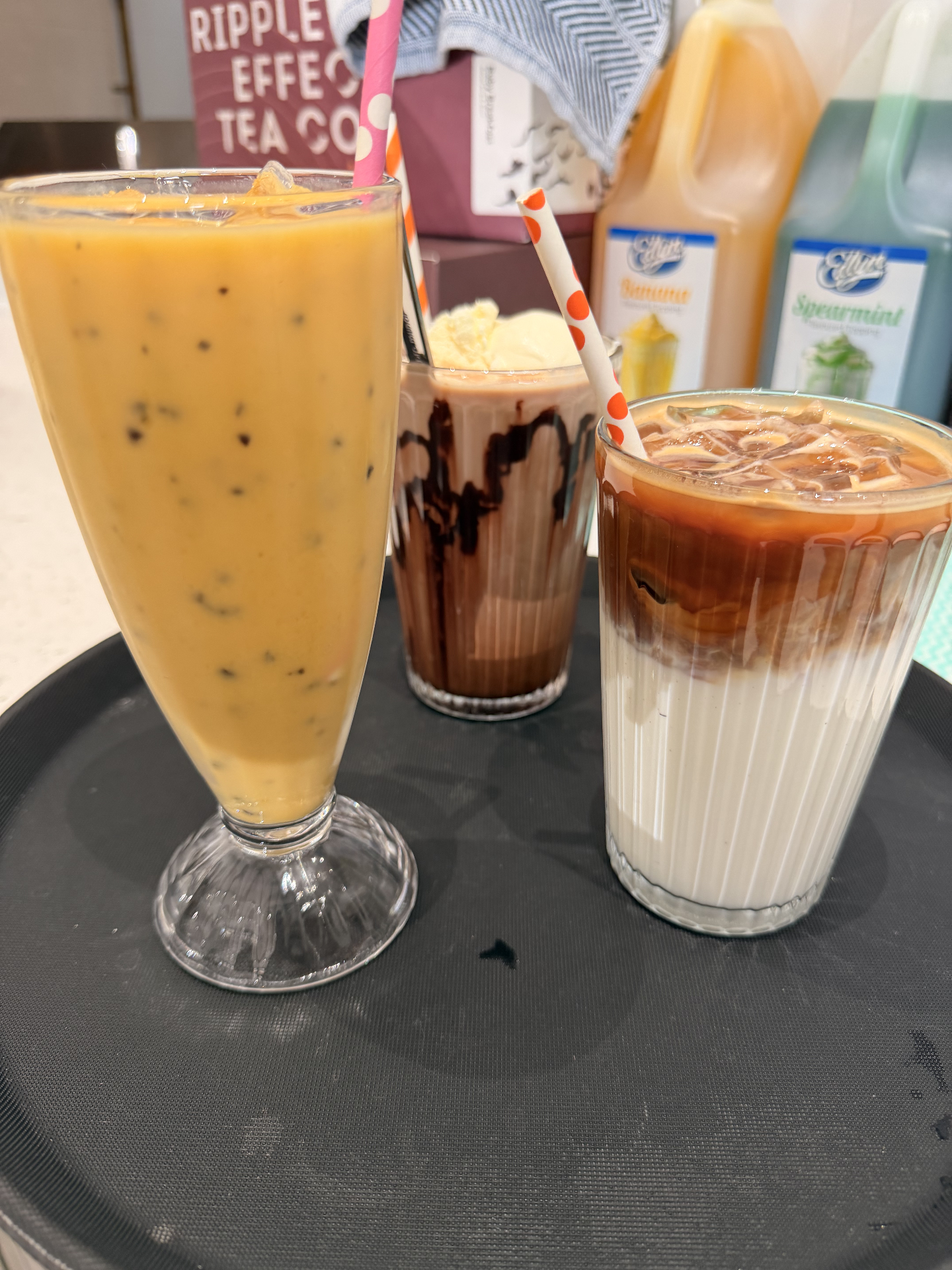 Iced coffee, iced chocolate and an iced latte on a tray