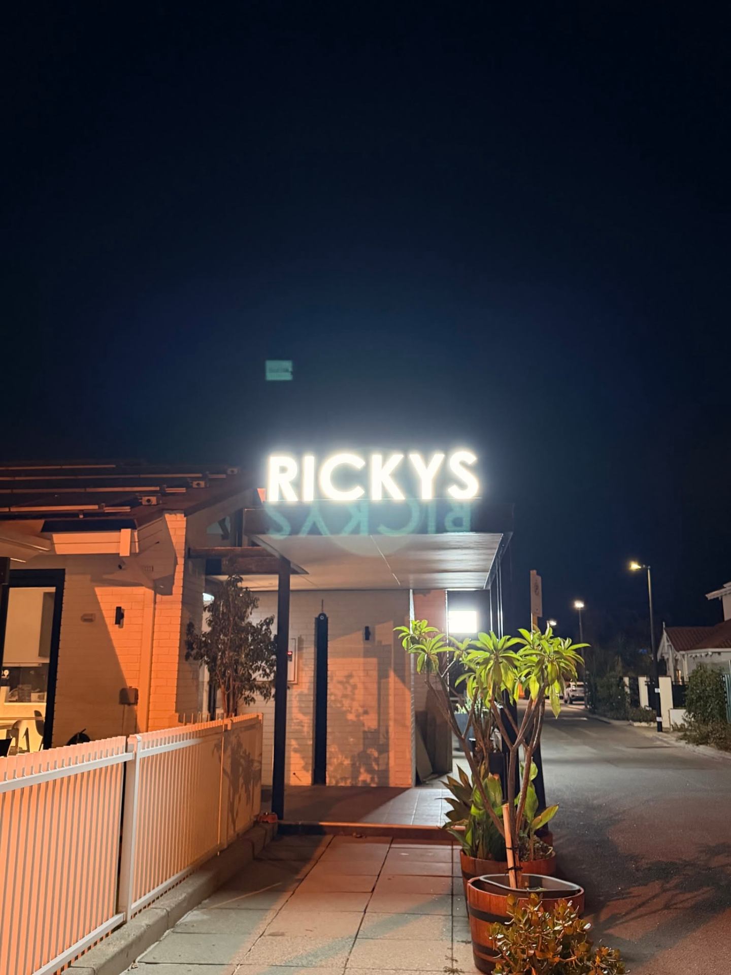 Ricky's illuminated signage at night